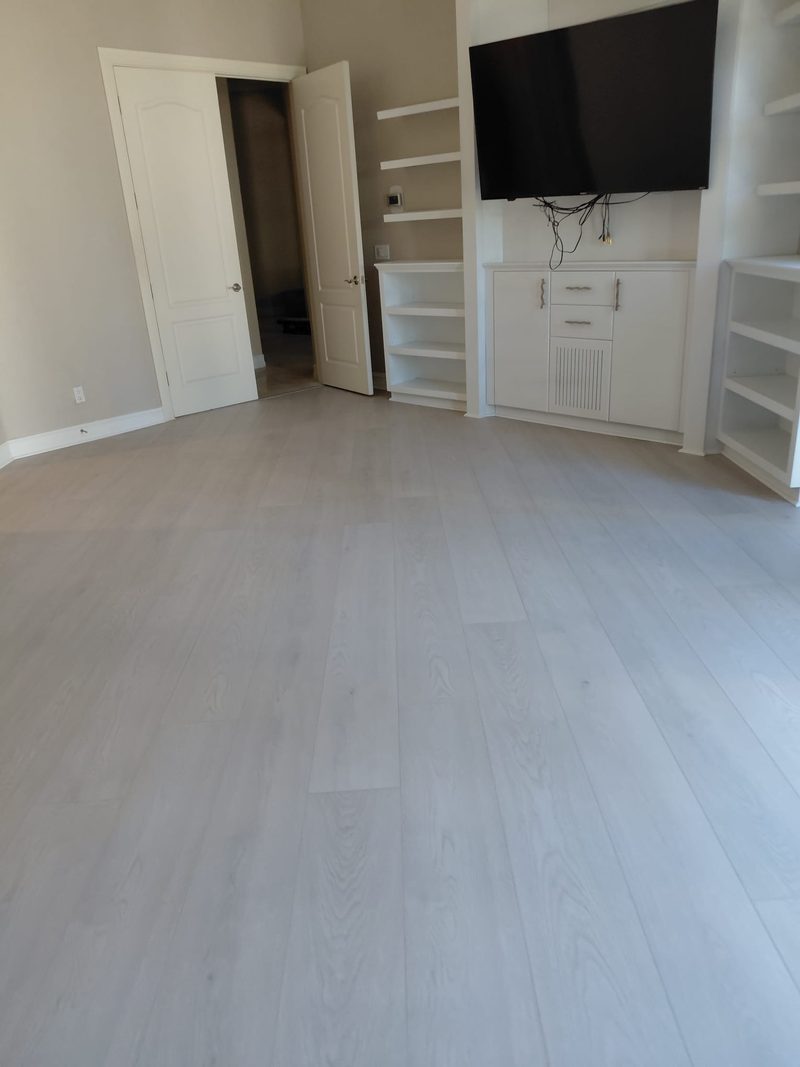 Light wide-plank flooring in a finished living room