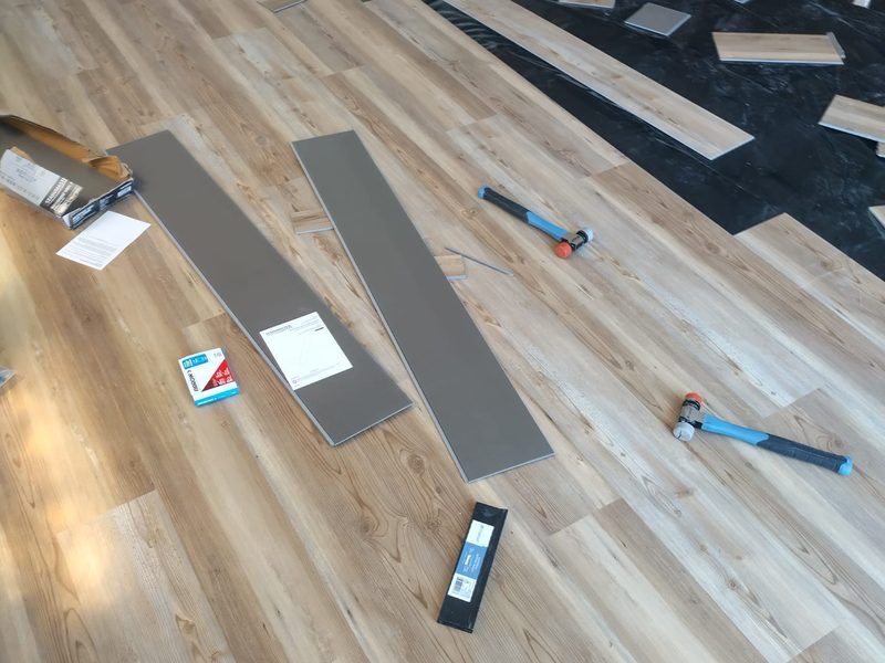 Waterproof vinyl plank flooring being installed